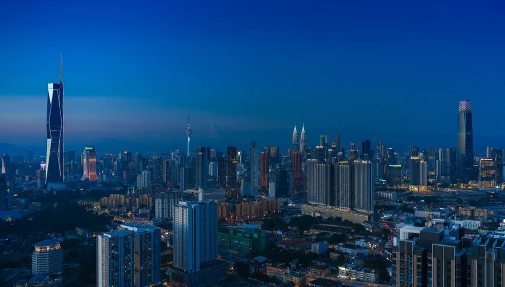 Kuala Lumpur skyline at evening with iconic landmarks reflecting in city lights