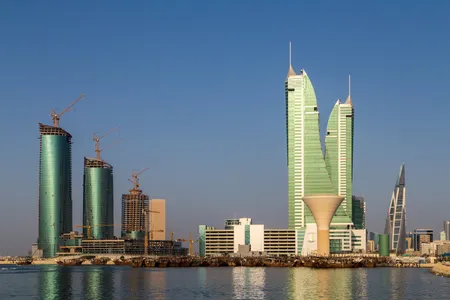 Bahrain Financial Harbour skyline with its iconic twin towers and traditional dhows in the foreground