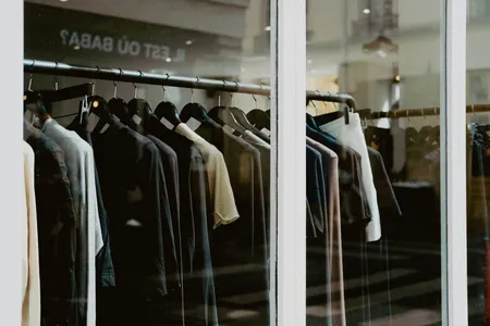 Clothing on hangers inside a fashion store window